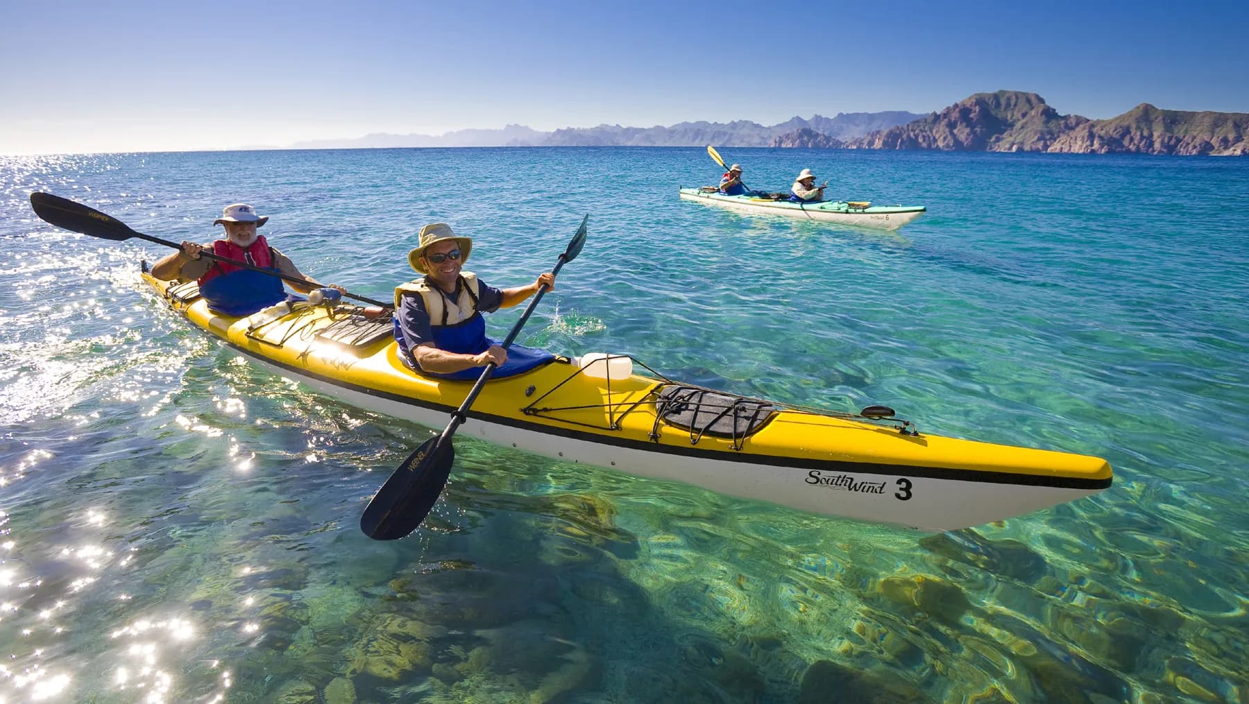 Kayaks on a calm coastal lagoon